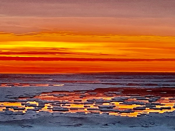 Fire and ice: Sunrise reflections on Lake Superior’s icy shoreline 
