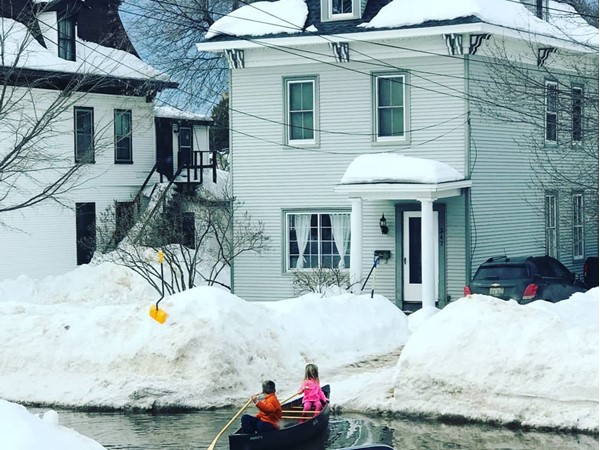  Neighbor kids canoeing down the street in the snow melt... Welcome to spring in Marquette