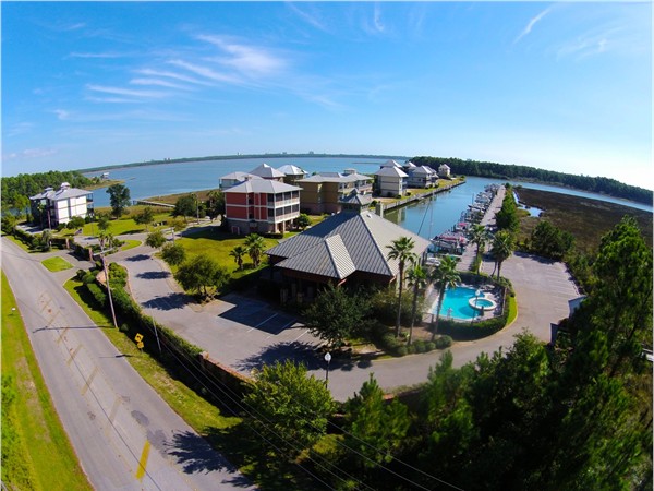 Aerial view of the clubhouse, pool and marina in gated Sunset Bay at Bon Secour! 