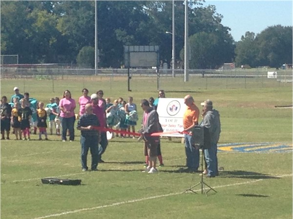 The ribbon cutting ceremony for the reopening of the Pee Wee football fields