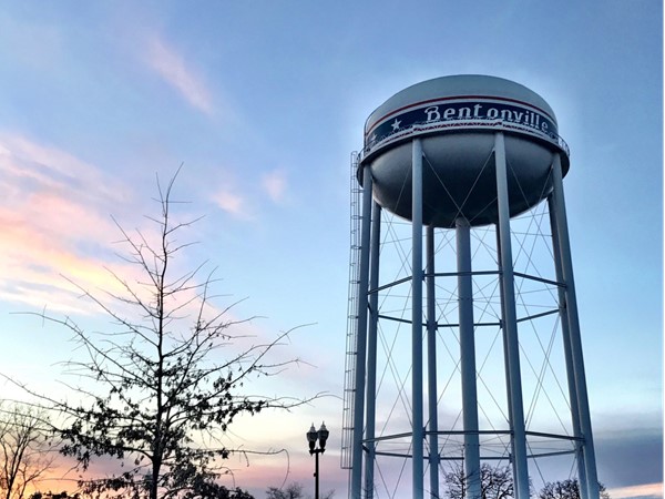 The colors of the sky are beautiful with the Bentonville water tower