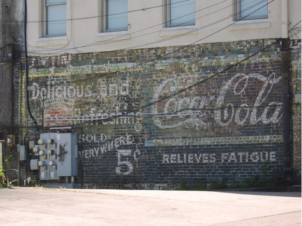 A landmark of the Depot District is the restored coke sign on the back of the wisteria building