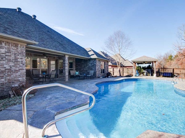 Beautiful Country Club of Arkansas home with lagoon style pool