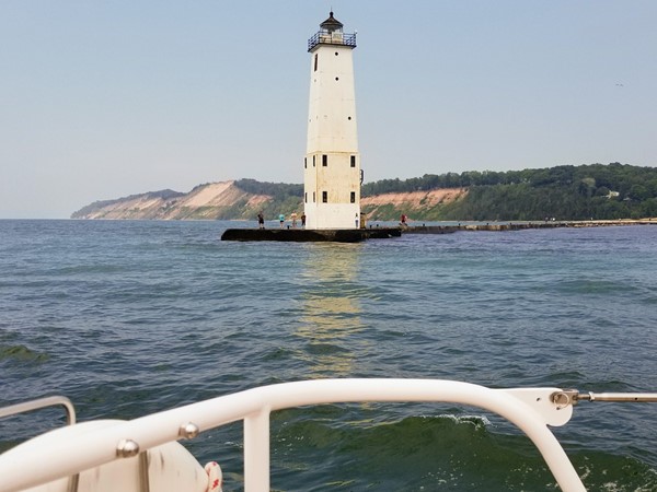 Sailing past the lighthouse in Frankfort Harbor, Lake Michigan