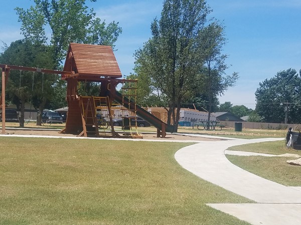 A place to hang out with the neighbors, a playground, walking trail, and picnic tables await you