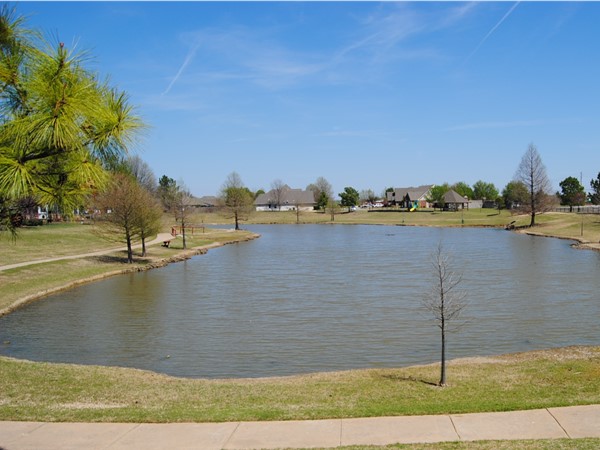 A view of one of two ponds with a walking trail, gazebo and playground to enjoy your afternoon