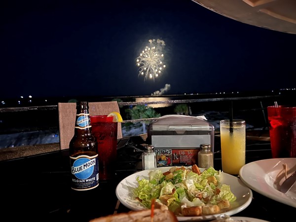 An amazing dinner & July 4th fireworks show from second floor open balcony at Pirates Bar & Grill