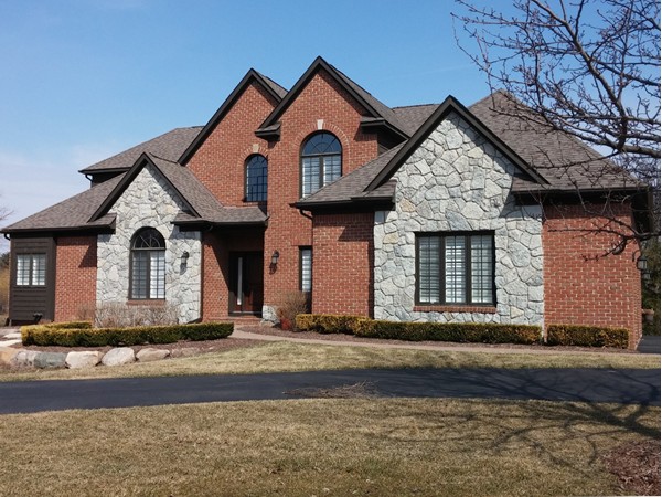 Brick and stone custom home in Meadows of Grand Blanc
