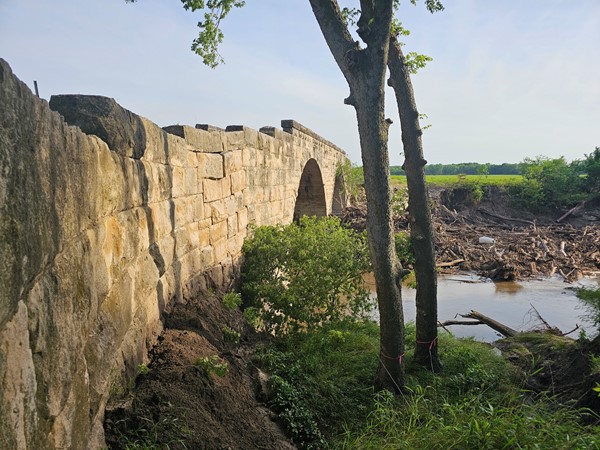 With towering stone and flowing water, this bridge blends beauty and history in one peaceful setting