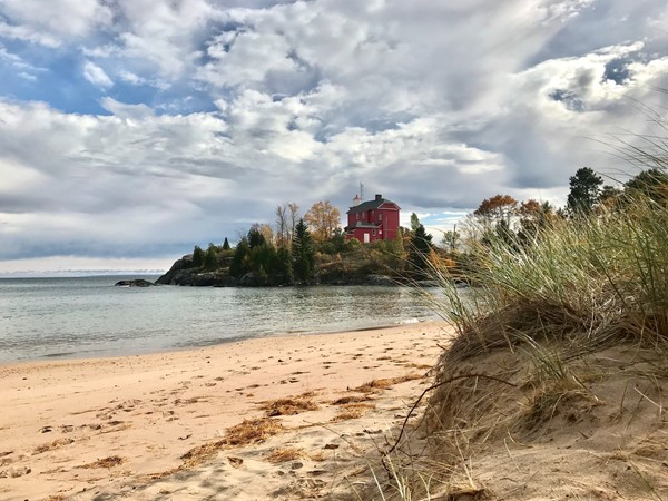 Marquette Harbor Lighthouse shines on a cool October day. Beautiful beach and landscape