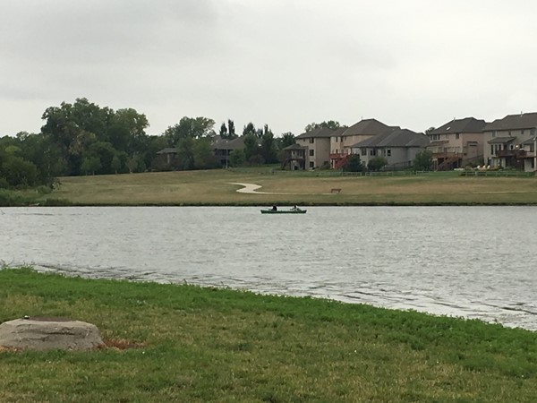 Canoers fishing and enjoying Whitehawk lake on a quiet weekday morning