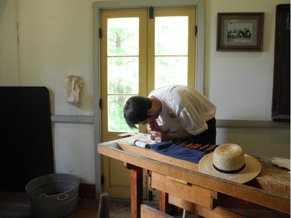 Carving the bow of a violin at the Vermilionville history museum and folklife park