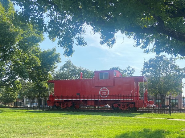 Big, historic red train in Downtown Lee’s Summit located across the street from the Whistle Stop