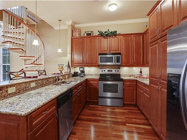 Condos have wood floors, stainless steel appliances, granite and covered parking