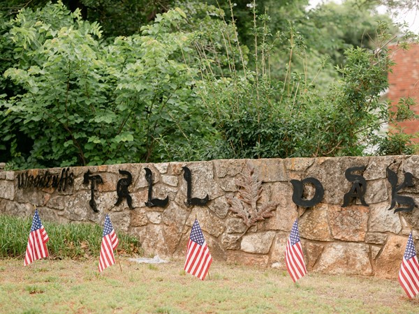 Woodruff Tall Oaks neighborhood entrance with American flags