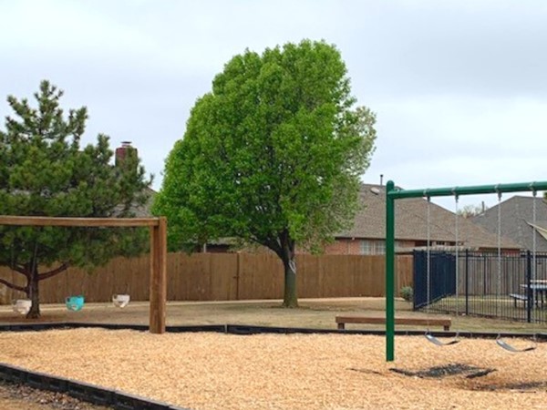 The park area offers a playground for community children, picnic areas, and seating