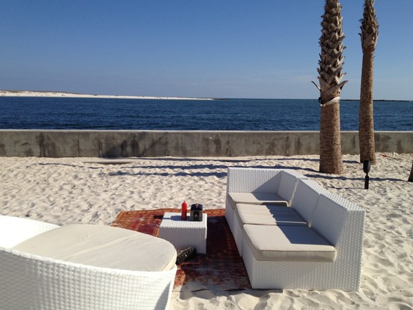 The Gulf's comfy, sandy outdoor setting on The Pass is perfect for a laid-back dinner and drinks!