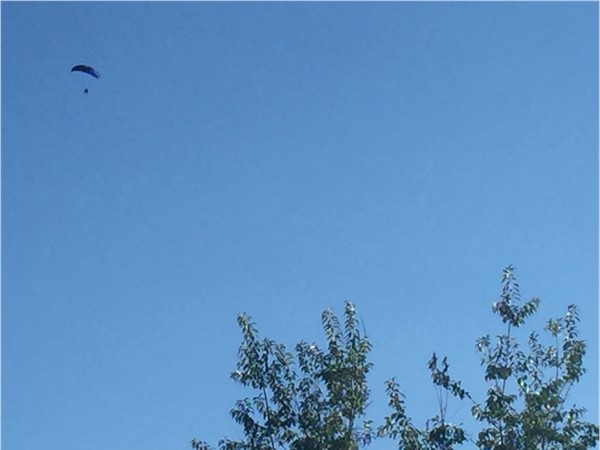 A parashooter gliding above Highridge Manor