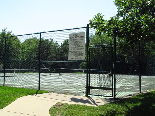 Tennis courts adjoin the pool area