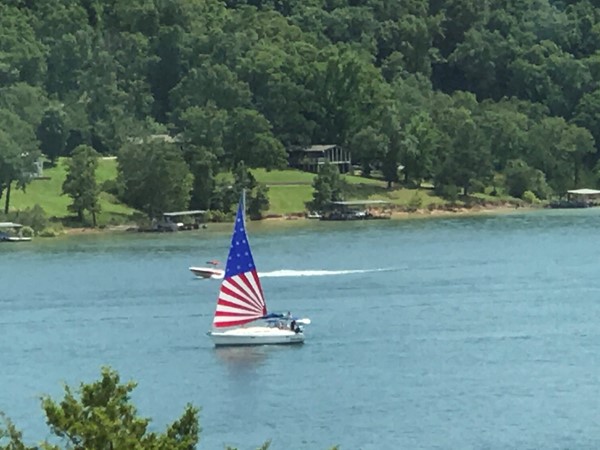 A colorful sailboat on Beaver Lake