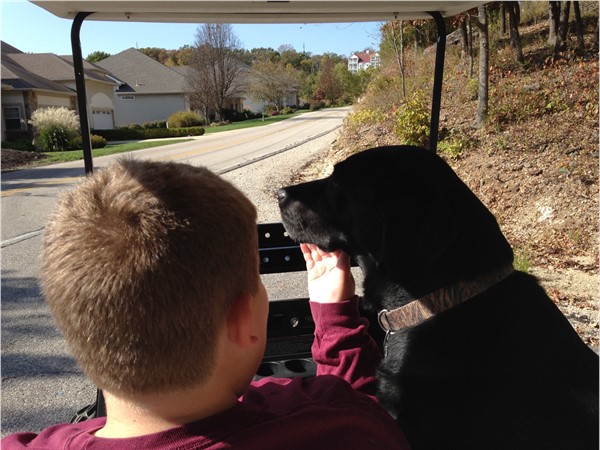 It's popular to see the owners take golf carts to the community dock. Sophie wanted a ride too