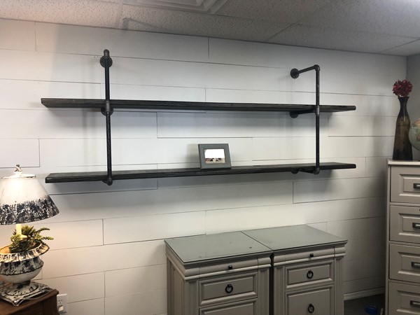 Shiplap wall with black plumbers pipe shelves