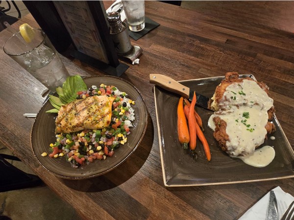 Iron House's Smothered Fried Chicken with carrots and salmon on southwest salad