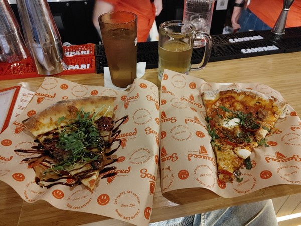 Mouthwatering pizza slices at Sauced