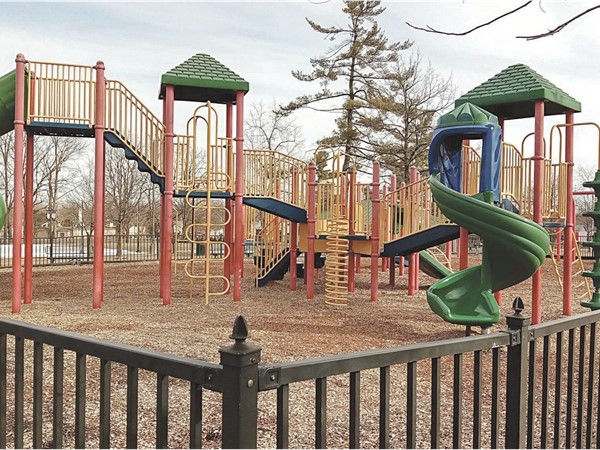 Physician's Park has fenced in playground and swings