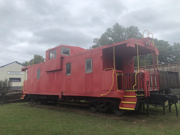 Red caboose train car at the historic Northport Train Depot