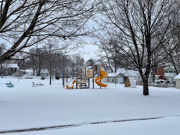 An unexpected March snowfall covers the playground equipment at Clay Street Park