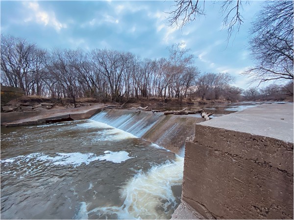 A shot of the Cottonwood River running through Emporia by “All Veterans Memorial”