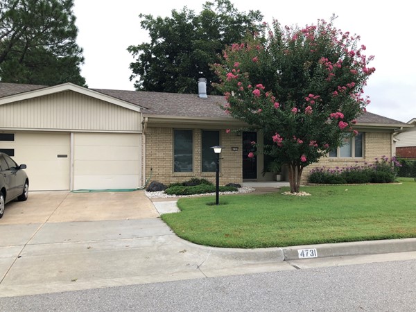 Nice Crepe Myrtle adds color to this home