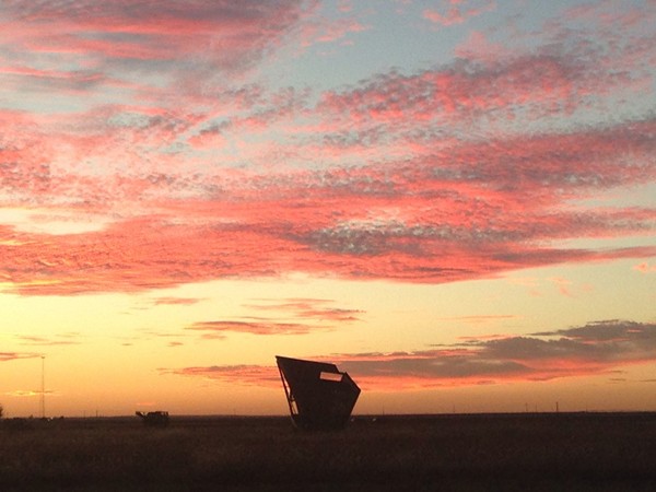 Altus sunset with a cotton stripper waiting for harvest 