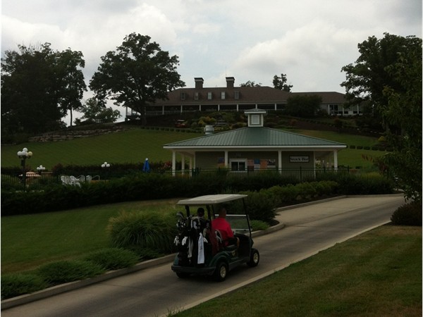 Golfer head to the clubhouse at Ozark National Golf Resort
