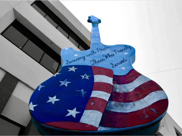 Red, white and blue guitar displayed in Muskogee