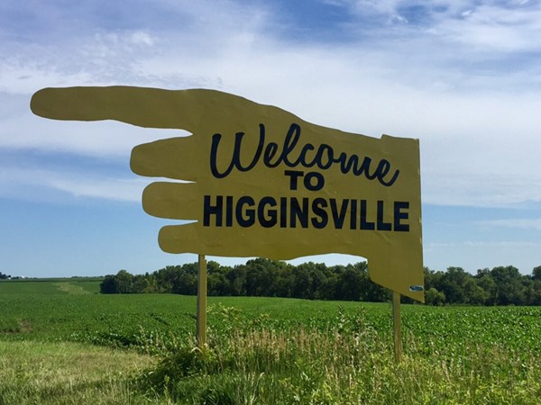 A large yellow sign points the way to Higginsville