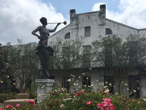 Statue of Terpsichore, the Greek Muse who inspires the arts and welcomes all to Coliseum Square