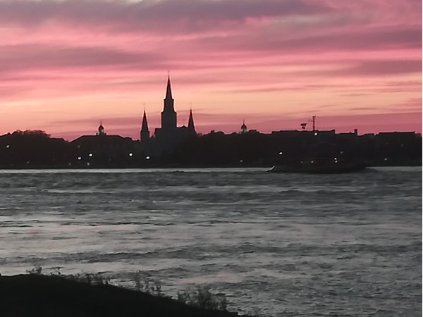 Mississippi River silhouette of St. Louis Cathedral. A view from Algiers Point levee in springtime