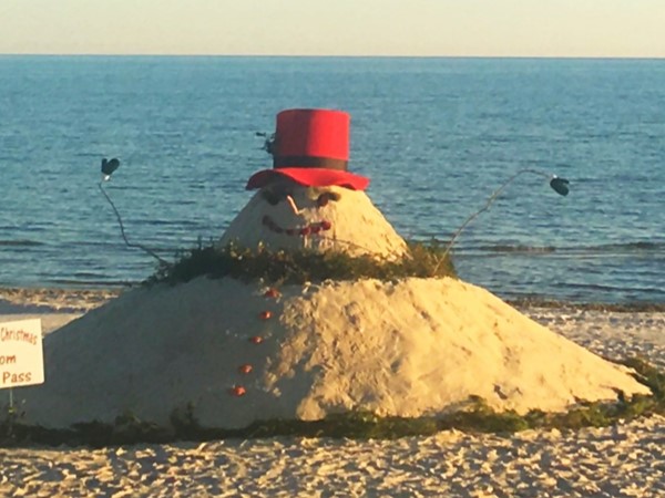 A jolly sand snowman on the beach in Pass Christian, MS