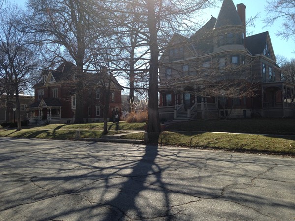 Sun shining behind the stately homes of Old West Lawrence