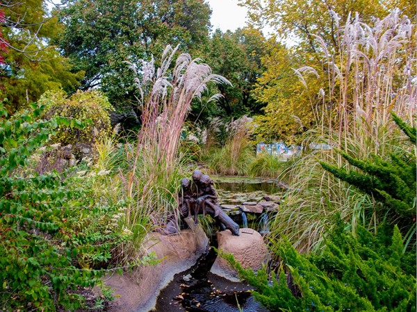 Natural grasses, ponds and statues are frequent at the Sedgwick County Zoo