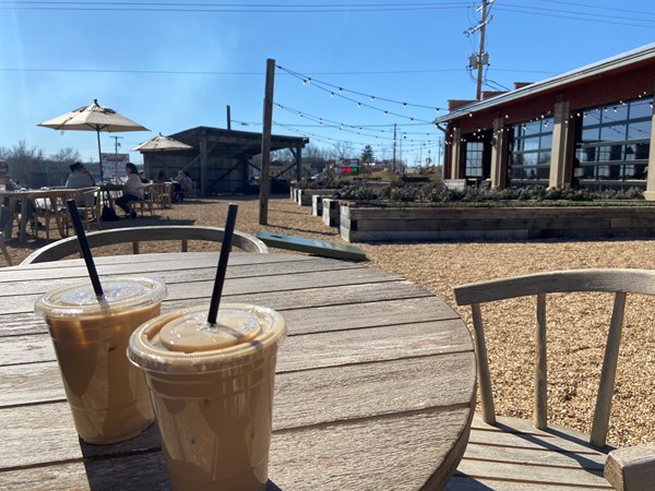 Enjoy your favorite iced latte at the trendy coffee shop The Workshop on a beautiful sunny day