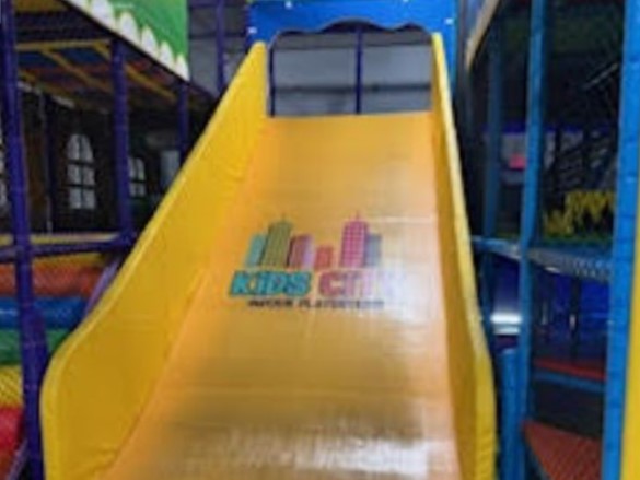 A fun yellow slide inside Kids City Indoor Playground