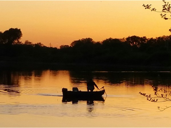 Fisherman at sunset on George Wyth Lake