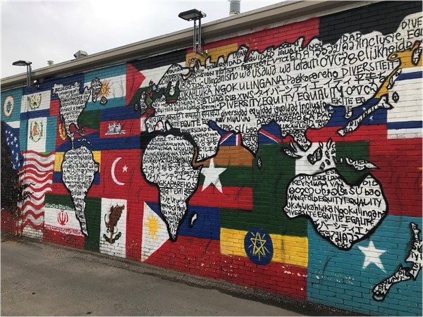 This amazing mural celebrates the diverse student population at NKC High School