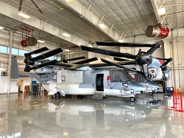 V-22 Osprey planes in hangar with wings folded.  Super cool