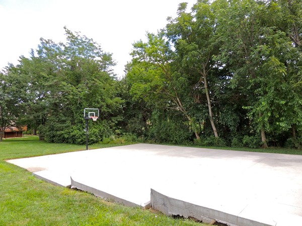Basketball court located near the pool, playground, and walking trail