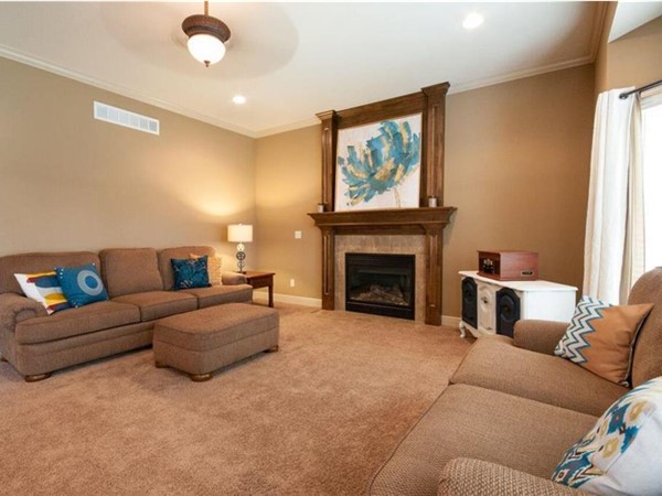 A staged living room by Staging Dreams at Eagle Creek Subdivision, in Lee's Summit