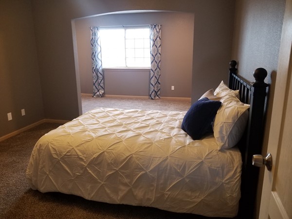 A staged master bedroom at Shadow Glen Townhomes by Staging Dreams